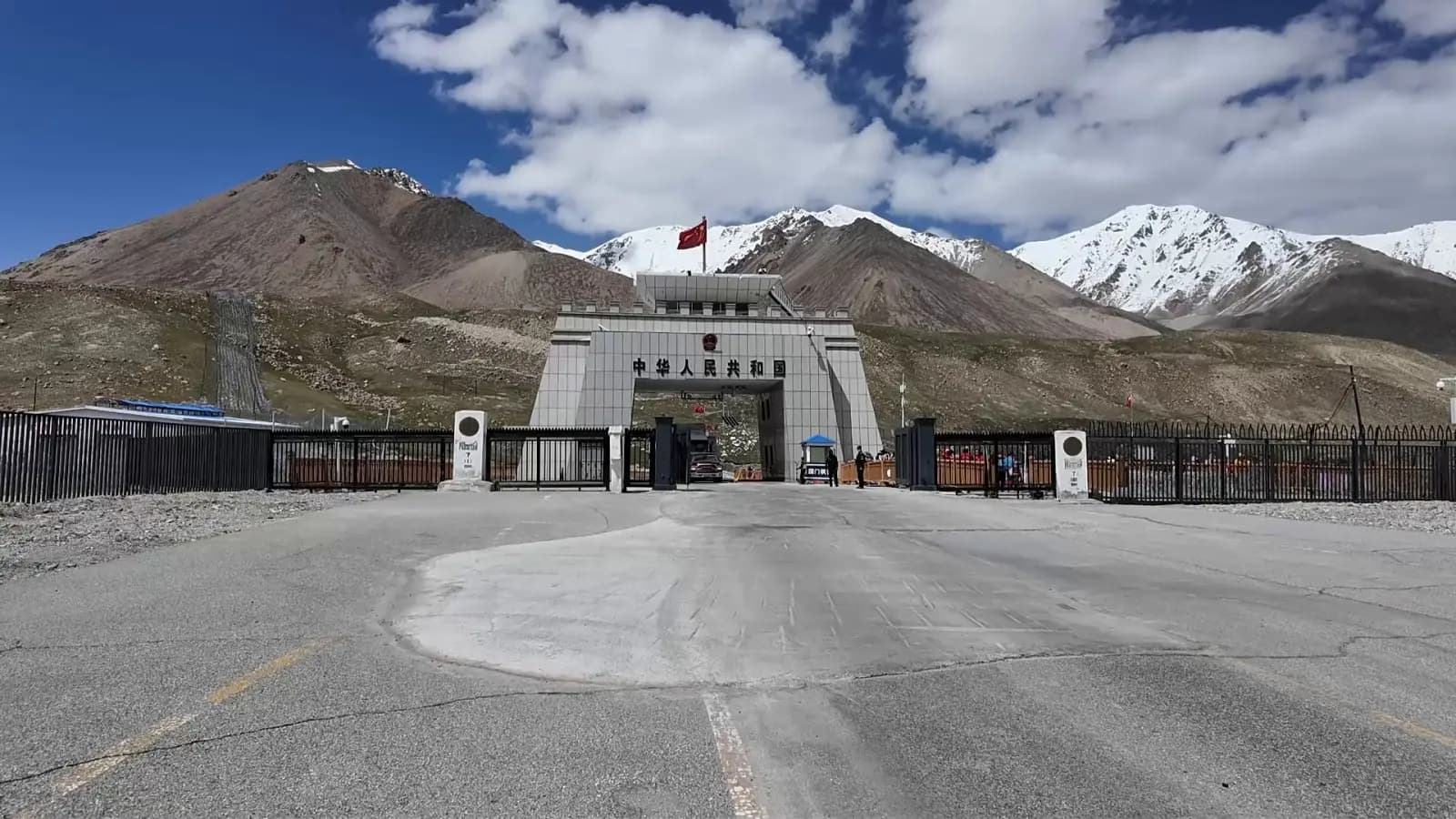 Khunjerab Pass China border gate at 4,693 m with snowy mountains